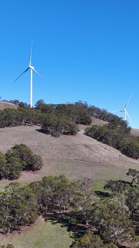 Wind Turbines Spinning on Rural Hillside in New South Wales