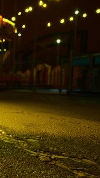 Soft golden light spills across the empty carnival ground, casting intriguing shadows. The colorful tents and distant carousel hint at the joy once alive here during festive nights.