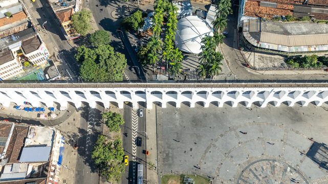 Arcos da Lapa featuring its iconic white arches stretching across the urban landscape with surrounding buildings and clear sky in Rio de Janeiro, Rio de Janeiro, Brazil. Aerial view.