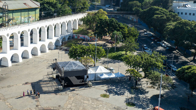 Arcos da Lapa featuring its iconic white arches stretching across the urban landscape with surrounding buildings and clear sky in Rio de Janeiro, Rio de Janeiro, Brazil. Aerial view.