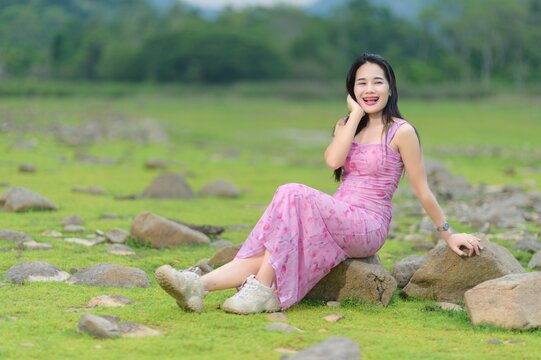 Young Woman in Pink Outfit Smiling by Sai Thong Reservoir, Thailand