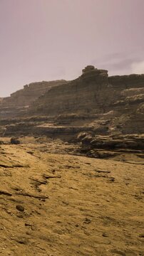 Under the gentle light of dusk, rugged rock formations rise majestically from the sandy ground. The vast desert stretches endlessly, inviting exploration and wonder.