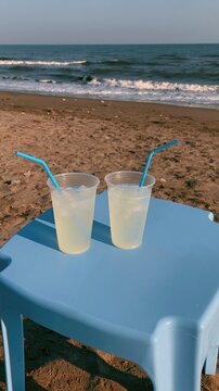 Refreshing Lemonade Cups on a Beach Table