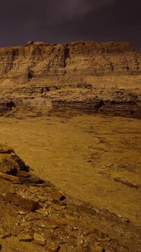 Under the enchanting glow of the moon, the rugged desert terrain reveals hidden textures and stunning layers, creating a tranquil scene that invites exploration and wonder.