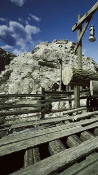 Weathered wooden beams lay scattered near rocky cliffs, holding echoes of past miners. A soft breeze flows through, hinting at untold tales of adventure and hard work in this ghostly landscape.