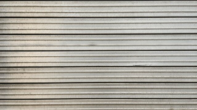 Metal roller shutter, corrugated steel texture, gray roller shutter, industrial texture with slight scratches or stains, metal steel door texture, texture