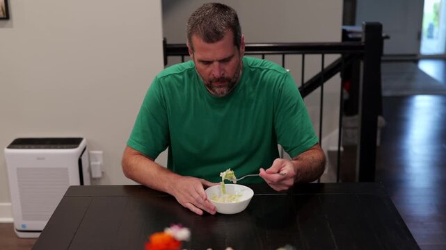 Man suffering severe stomach pain and cramps after eating shredded iceberg lettuce contaminated foodborne illness, illustrating salad recall symptoms
