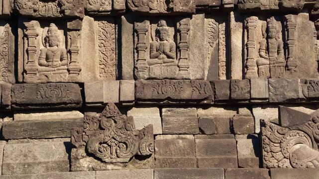 Weathered narrative relief carvings line the ancient stone walls of Prambanan Temple, preserving detailed Hindu artistry.