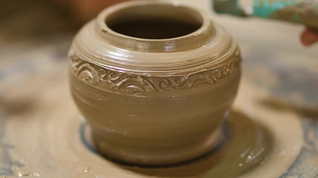 Artisan Carving Intricate Patterns on Clay Pot in Nonthaburi Thailand