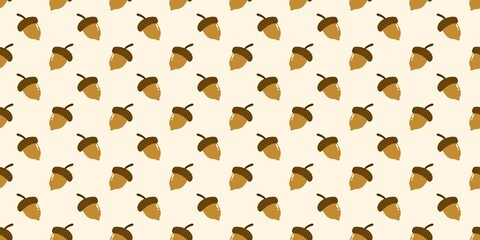 Seamless acorns pattern. Cute cartoon acorns on light cream background. Perfect for autumn wallpaper and fall textile design. © Enka Enka