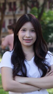 Smiling Asian University Student with Braces Standing Outdoors on Campus
