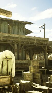 Amidst a warm sunlit day, a rustic western town showcases wooden buildings and aged wagons. The scene captures the essence of old time adventure and exploration in natures embrace.