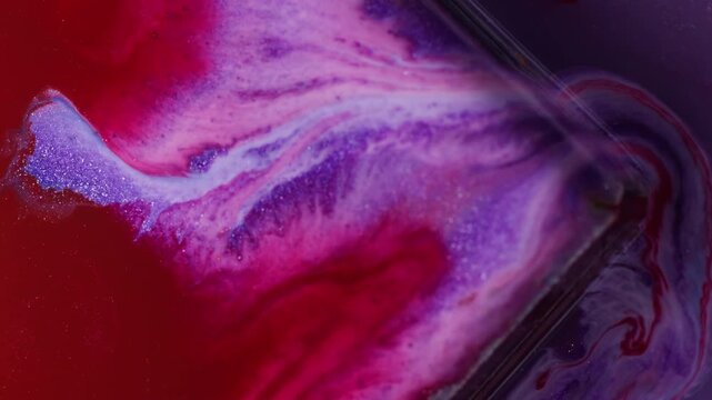 Ink drip. Glass cube angle. Defocused red purple maroon color geometric texture bright droplets flowing on abstract art background.