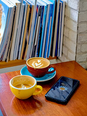 Warm café scene featuring specialty coffee, espresso, and a reading corner © Cindy