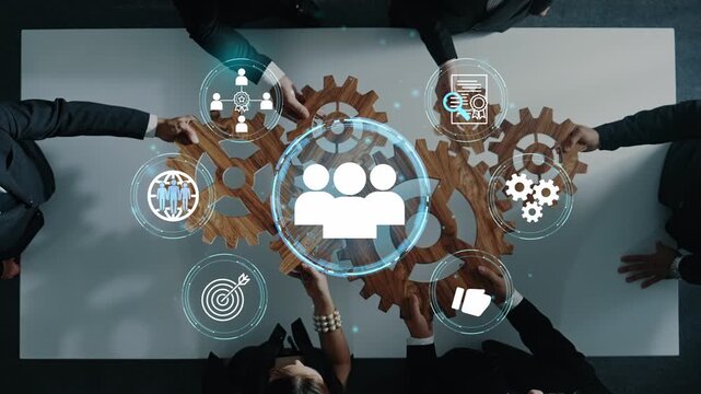 A professional team collaborates on strategy development, represented by gears and icons, showcasing teamwork in a modern office environment focused on innovation and success. Entropy.