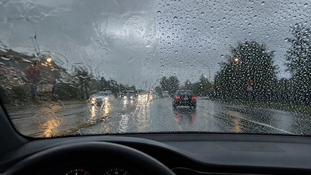 Car windshield split view showing rain repellent coating effect