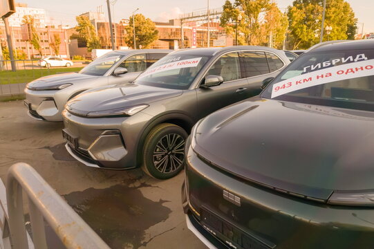 Russia, Samara. July 1, 2026: A Geely EX5 EM-i crossover with a closed panel and futuristic design in Samara. Text in Russian: 943 km on one tank