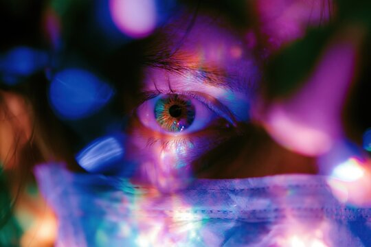 Extreme close up of a human eye through surgical microscope optics for ophthalmic surgery and vision care concepts, featuring neon flares