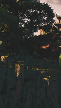 Ancient trees tower over a lush hillside, embracing a striking red pagoda. The sun sets, casting golden light on rugged rocks, creating a serene atmosphere filled with wonder.