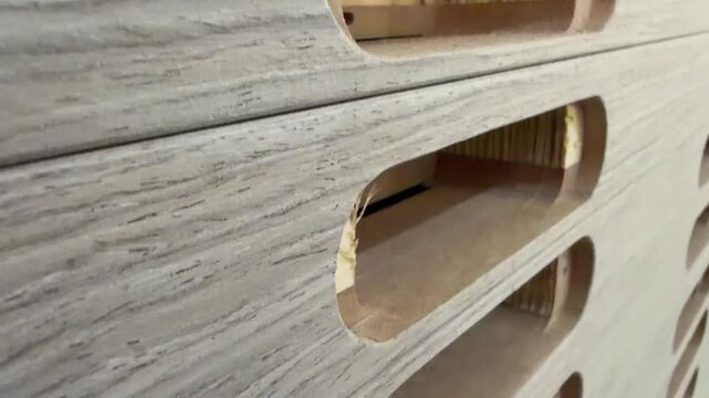 milled recesses for concealed door hinges on veneered door panel, precision hinge pockets in engineered wood