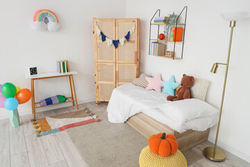 Fototapeta premium Interior of childrens room with bed, closet and bookshelf