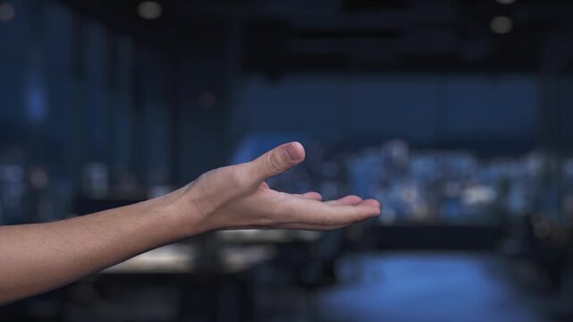 A robotic hand extends toward a human hand, symbolizing the intersection of artificial intelligence and human interaction in a sleek, modern workspace environment. Synapse