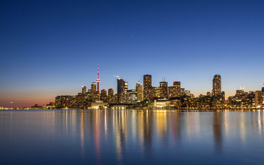 Naklejka premium Toronto Skyline at Blue Hour Reflecting on Lake Ontario, Canada