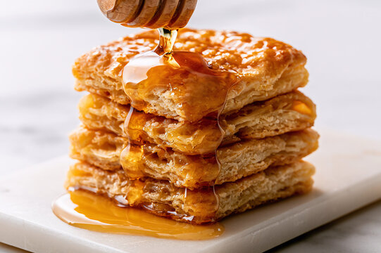 square-cut biscuit stack drenched in dripping amber honey