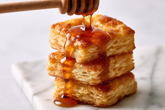 square-cut biscuit stack drenched in dripping amber honey