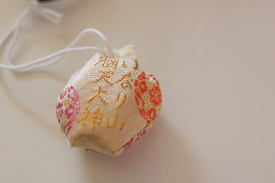 Japanese omamori amulet charm with gold embroidery close up