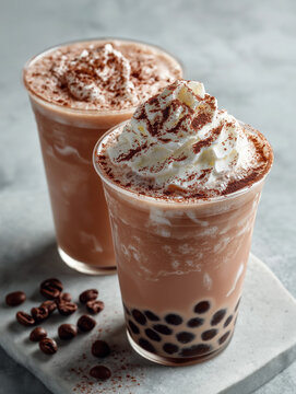 Boba tea drinks sit on a textured stone surface.