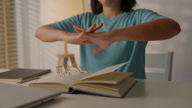Asian business woman having neck pain during working at home in her home office.