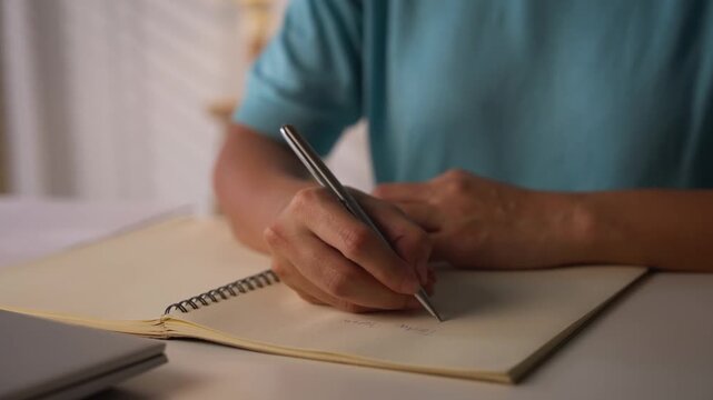 Asian woman works from home, surrounded by notes, a laptop, and messages. She browses the internet, writes ideas, and researches for her startup, utilizing wireless technology.