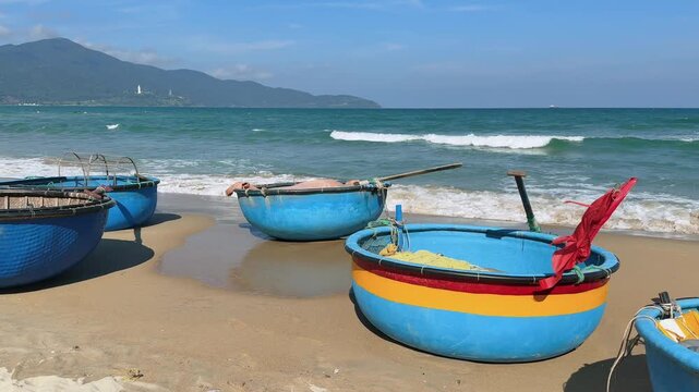 Multiple Vietnamese Basket Boats on Beach with Mountain Backdrop Vietnam