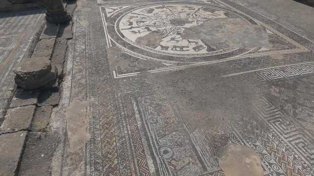 Close view of remarkably preserved Roman mosaic floors at the UNESCO-listed Volubilis archaeological site in Morocco, highlighting intricate geometric patterns and ancient craftsmanship.
