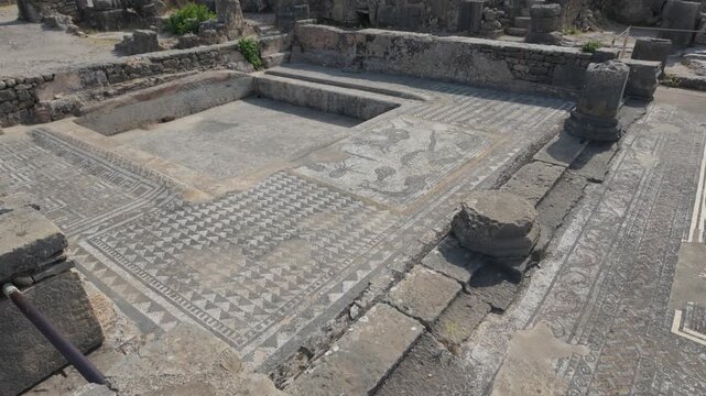 Ground-level view of the Roman Orpheus mosaic at the UNESCO-listed Volubilis archaeological site in Morocco, showcasing intricate ancient craftsmanship and remarkably preserved floor decoration.
