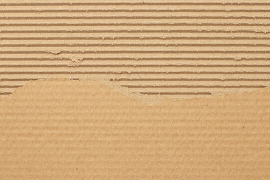 Brown cardboard sheet abstract background, texture of recycle paper box in old vintage pattern with ripped edges.