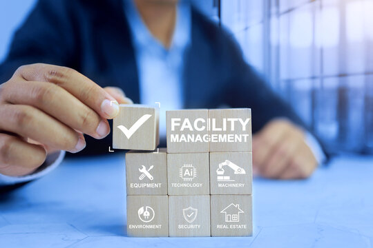 facility management concept with a businessman arrange wooden cube represents prepare and planning for factory infrastructure