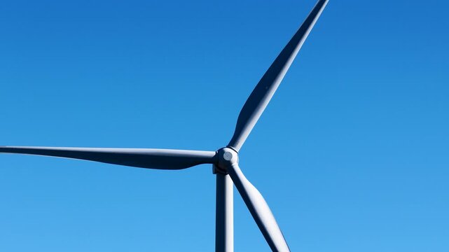 Wind Turbine Propeller Rotating Against Clear Blue Sky in Australia