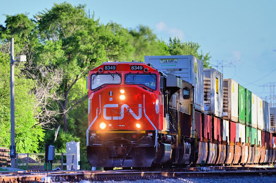 Multiple Canadian National Railway locomotives are on the front end of a container train as it moves northbound through northern Illinois.