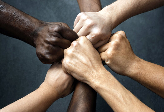Diverse group of hands stacked together showing unity teamwork and solidarity in powerful gesture