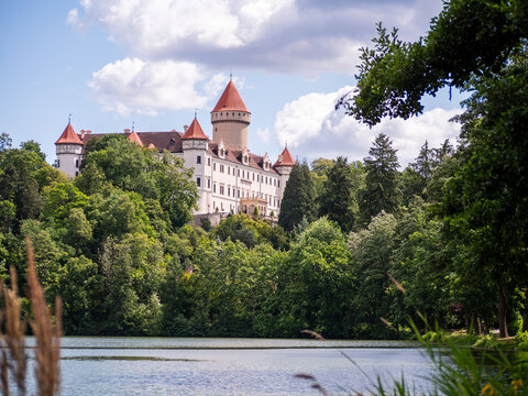 Konopiste Castle, former residence of Archduke Franz Ferdinand, overlooking a lake and green park near Benesov, Czech Republic, on a sunny summer day.