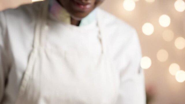 A skilled artisan meticulously garnishes a dessert with a vibrant flower, showcasing culinary artistry and attention to detail in a beautifully decorated kitchen environment.
