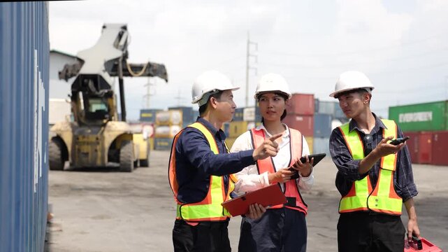 Container terminal worker performs routine inspection across shipping yard. Logistics planning, cargo tracking and warehouse operations support.