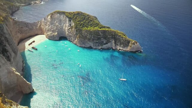 Stunning aerial view of navagio beach and shipwreck cove in zakynthos greece, showcasing turquoise waters and dramatic cliffs.