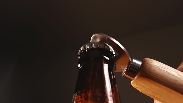Bottle Opener Removing Cap from Glass Beer Bottle Close Up