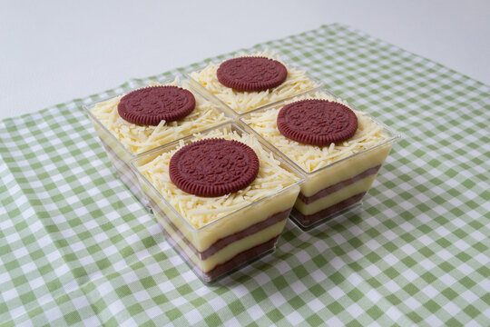 Steamed sponge cakes or bolu kukus topped with creamy white vla filling and red velvet cookies