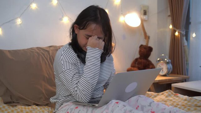 Young girl was using laptop and eyes were so tired had to take a nap in comfortable bedroom