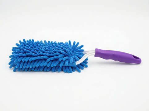Blue microfiber duster with a purple handle for household cleaning and dusting chores isolated on white background , png