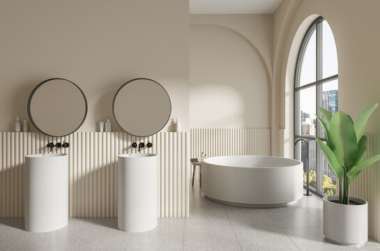 Contemporary bathroom with pedestal sinks, round mirrors, and freestanding tub in a minimalist 3D Rendering on a warm beige background, expressing luxury
